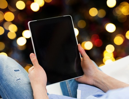 close up of male hands holding tablet pc