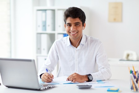 businessman in earphones working at office