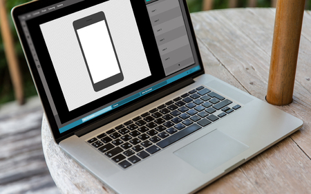 laptop with smartphone image in graphics editorの写真素材