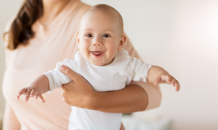 family, motherhood and people concept - close up of mother with little baby boy at homeの写真素材