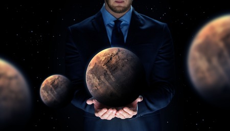 close up of businessman with planet hologramの写真素材