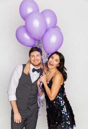 happy couple with ultra violet balloons at partyの写真素材