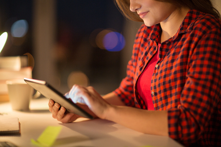 close up of student woman with tablet pc at homeの写真素材