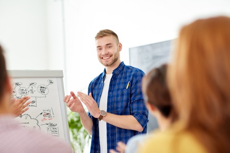 creative team with scheme on flipboard at officeの写真素材