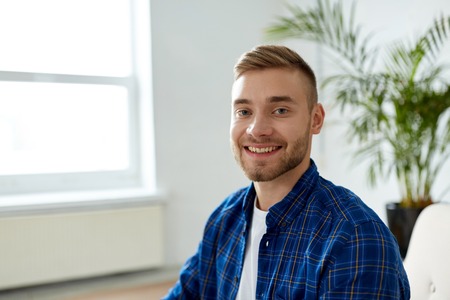 portrait of happy smiling young man at officeの写真素材