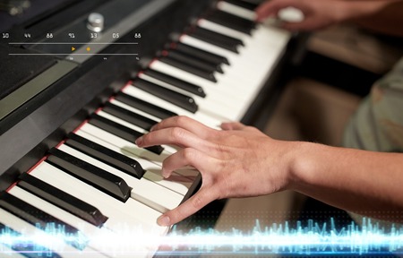 hands playing piano at sound recording studioの写真素材