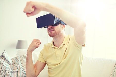 young man in virtual reality headset or 3d glassesの写真素材