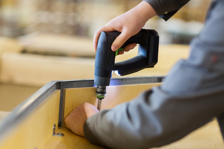assembler with screwdriver making furnitureの写真素材