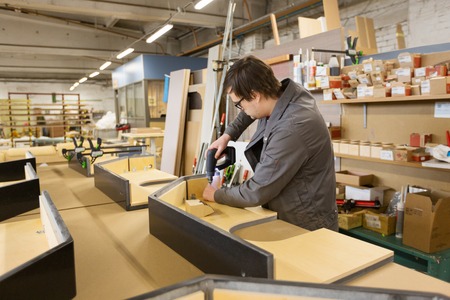 assembler with screwdriver making furnitureの写真素材