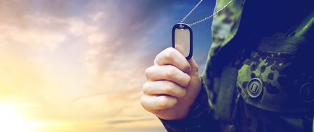 close up of young soldier with military badgeの写真素材