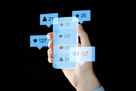 hand with social media icons on smartphoneの写真素材