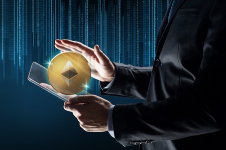 businessman with tablet pc and ethereum hologram