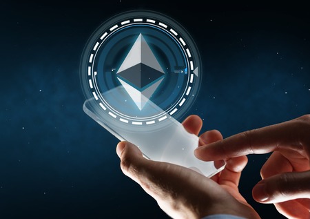 businessman with smartphone and ethereum hologram
