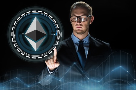 businessman hand with ethereum hologram over black