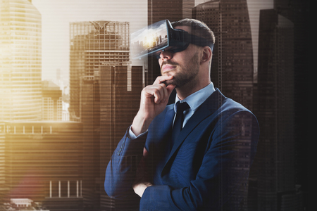 3d technology, virtual reality, cyberspace and augmented reality concept - young businessman with singapore city on virtual headset or 3d glasses screen over double exposure effect backgroundの写真素材