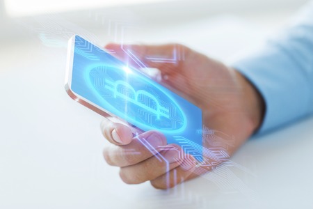 close up of bitcoin on transparent smartphoneの写真素材