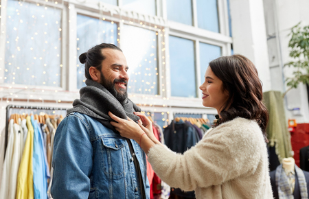 couple choosing clothes at vintage clothing storeの写真素材
