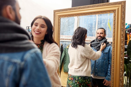 couple choosing clothes at vintage clothing storeの写真素材