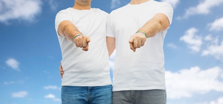 couple with gay pride rainbow wristbandsの写真素材