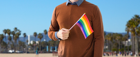 close up of man with gay pride rainbow flagの写真素材