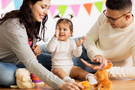 baby girl with parents clapping handsの写真素材