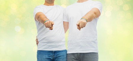 couple with gay pride rainbow wristbandsの写真素材