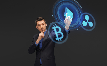 businessman with cryptocurrency hologramsの写真素材