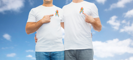 close up of couple with gay pride rainbow ribbonsの写真素材