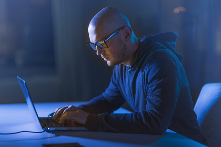 hacker using laptop computer for cyber attackの写真素材