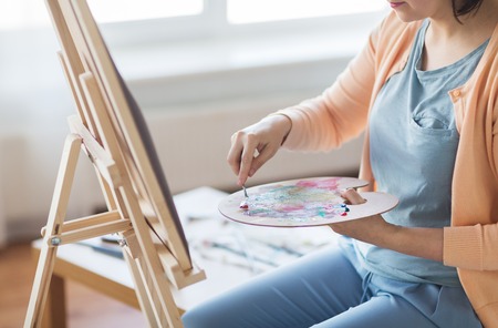 artist with palette knife painting at art studioの写真素材