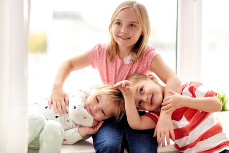 happy little kids having fun at windowの写真素材