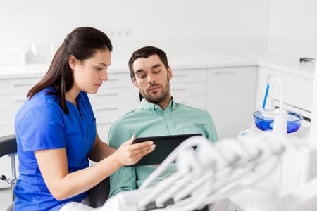 dentist and patient with tablet pc at clinicの写真素材