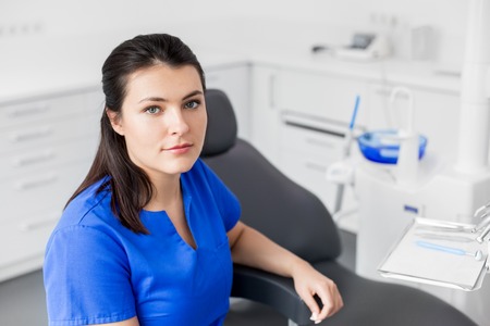 female dentist or nurse at dental clinic officeの写真素材