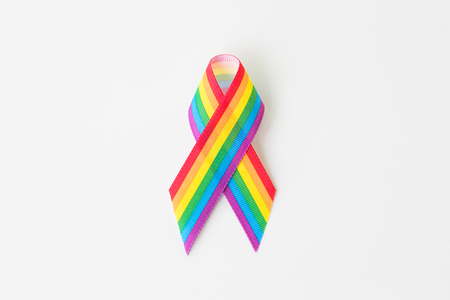 close up of gay pride awareness ribbon on whiteの写真素材