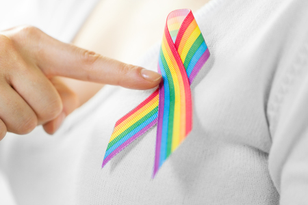 woman with gay pride awareness ribbon on her chestの写真素材
