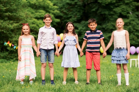 happy kids on birthday party at summer parkの写真素材