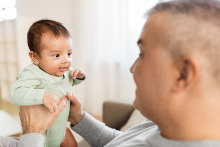 happy father with little baby boy at homeの写真素材