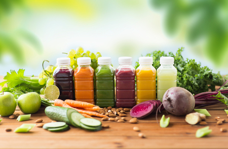 bottles with different fruit or vegetable juicesの写真素材