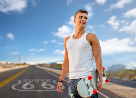 man with skateboard over us route 66 backgroundの写真素材