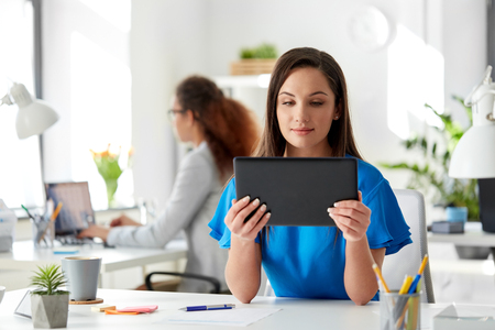 businesswoman with tablet pc working at officeの写真素材