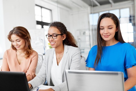 businesswomen with laptops working at officeの写真素材