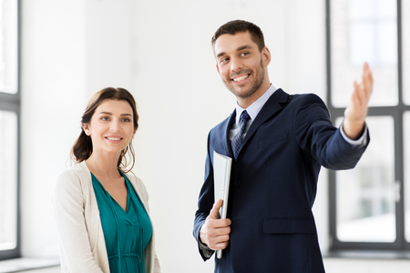 realtor showing new office room to female customerの写真素材