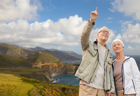 happy senior couple over big sur coastの写真素材
