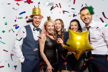 friends with party props and confetti laughing
