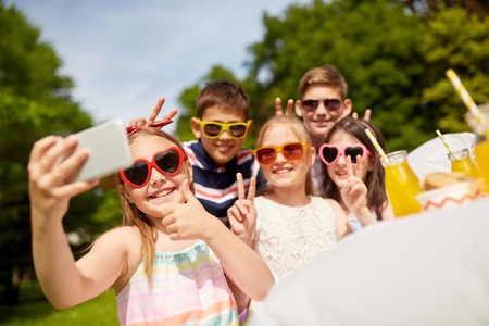 happy kids taking selfie on birthday party