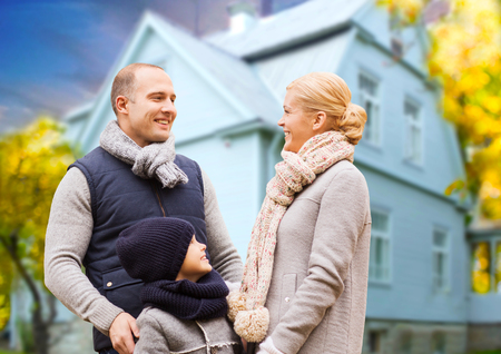 happy family over living house in autumnの写真素材