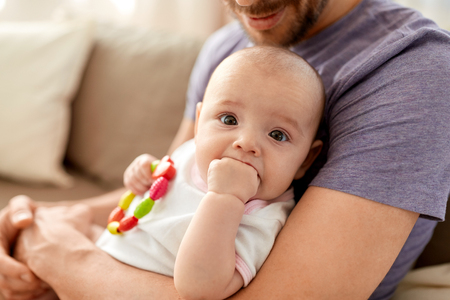 close up of father with little baby girl at homeの写真素材