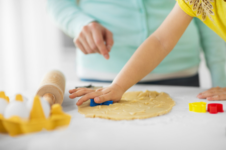 mother and daughter making cookies at homeの写真素材