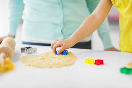 mother and daughter making cookies at homeの写真素材