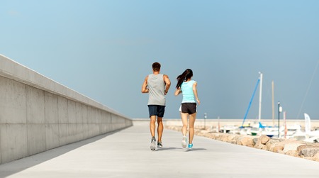 couple in sports clothes running outdoors
